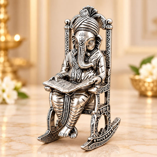 Divine Wisdom Ganesha Figurine – Silver-Toned Reading Pose, Ornate Chair (11x3x5 inches)